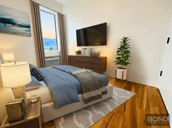 a bedroom with a bed and a flat screen tv