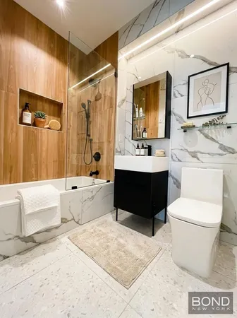 a bathroom with a sink a toilet and bathtub
