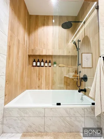 a bathroom with a bathtub and shower