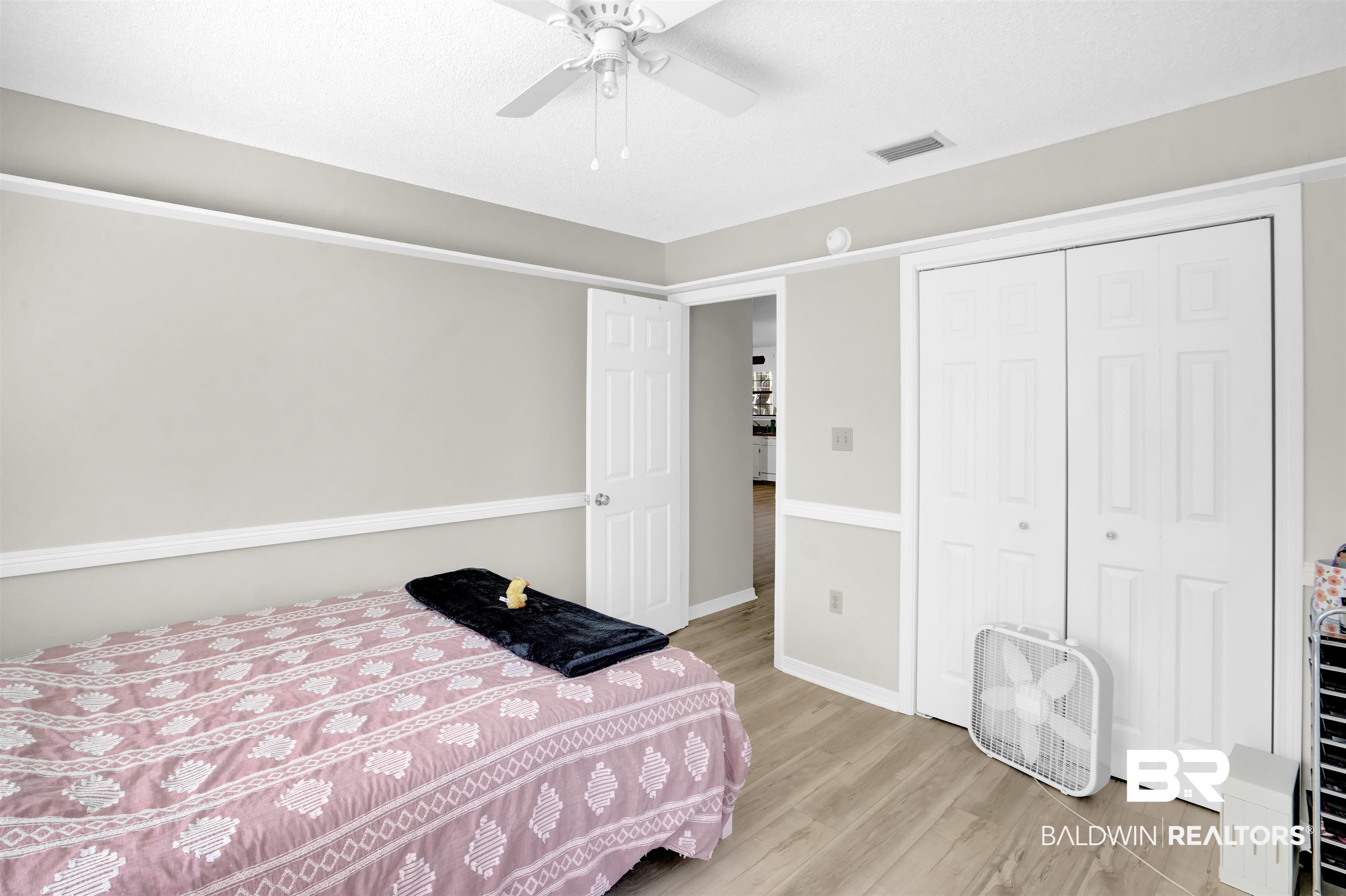 30871 Stanton Road Spanish Fort, AL 36527 - Photo 19 of 35 Bedroom featuring a closet, ceiling fan, and light hardwood / wood-style floors