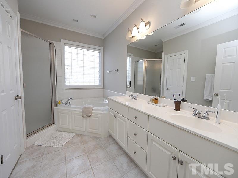 3209 Tall Tree Place Raleigh, NC 27607 - Photo 14 of 22 a spacious bathroom with a double vanity sink toilet mirror and bathtub