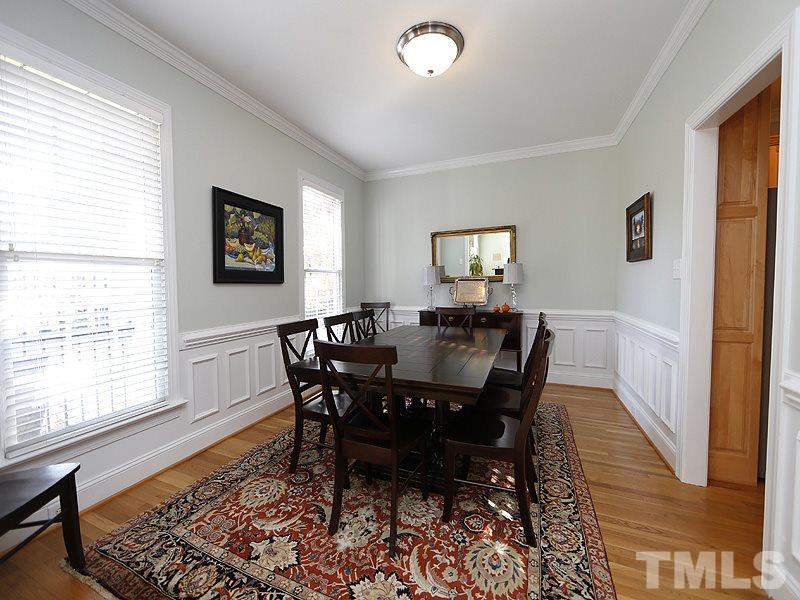 3209 Tall Tree Place Raleigh, NC 27607 - Photo 4 of 22 a view of a dining room with furniture and wooden floor