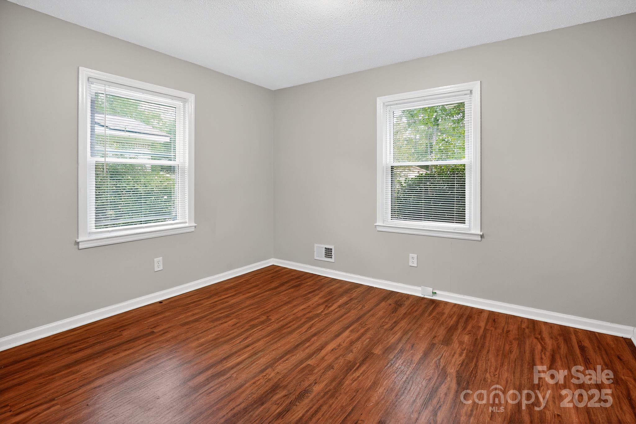 3725 Harrogate Road Columbia, SC 29210 - Photo 11 of 31 a view of an empty room with wooden floor and a window