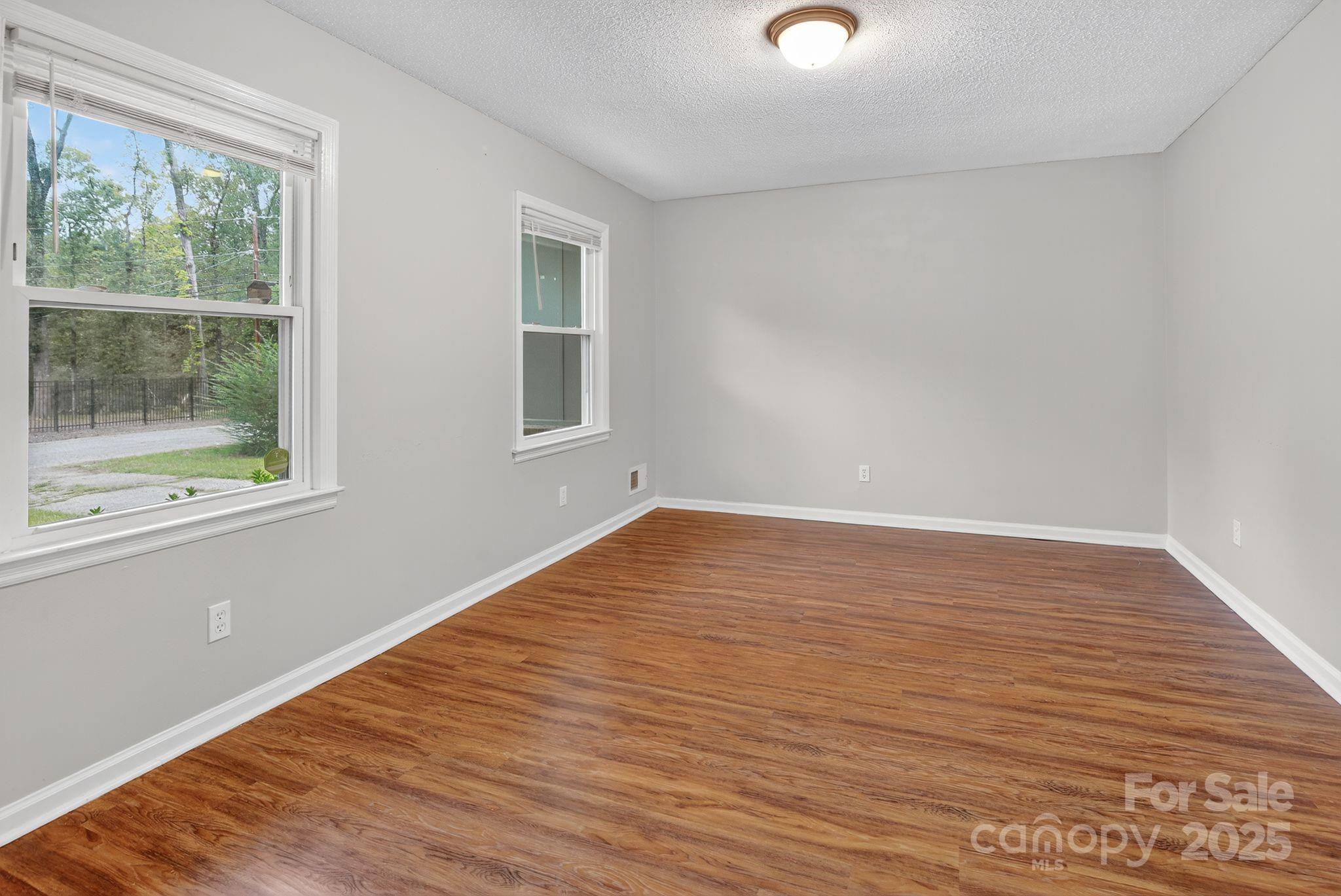 3725 Harrogate Road Columbia, SC 29210 - Photo 13 of 31 a view of an empty room with wooden floor and a window
