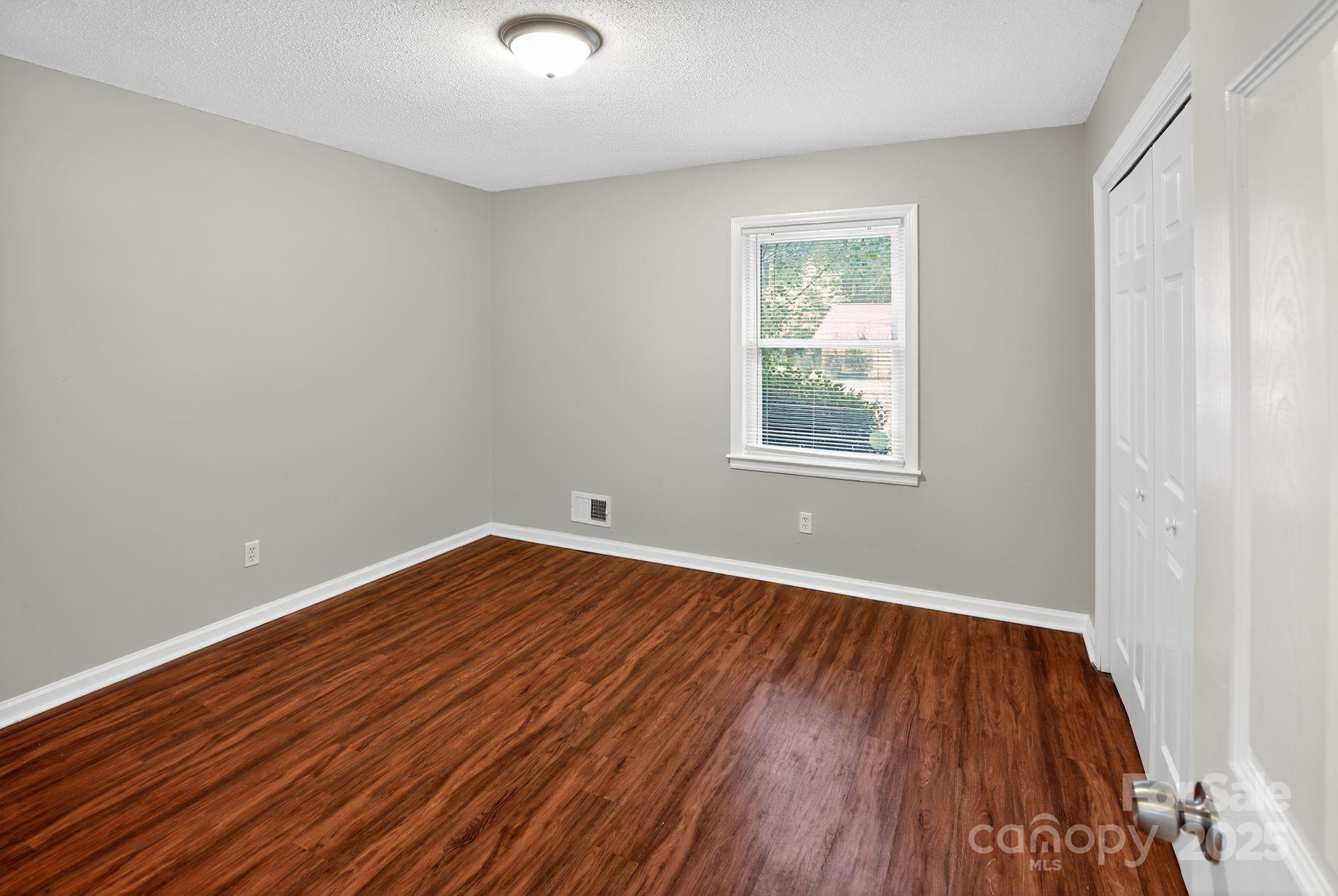 3725 Harrogate Road Columbia, SC 29210 - Photo 23 of 31 an empty room with wooden floor and windows