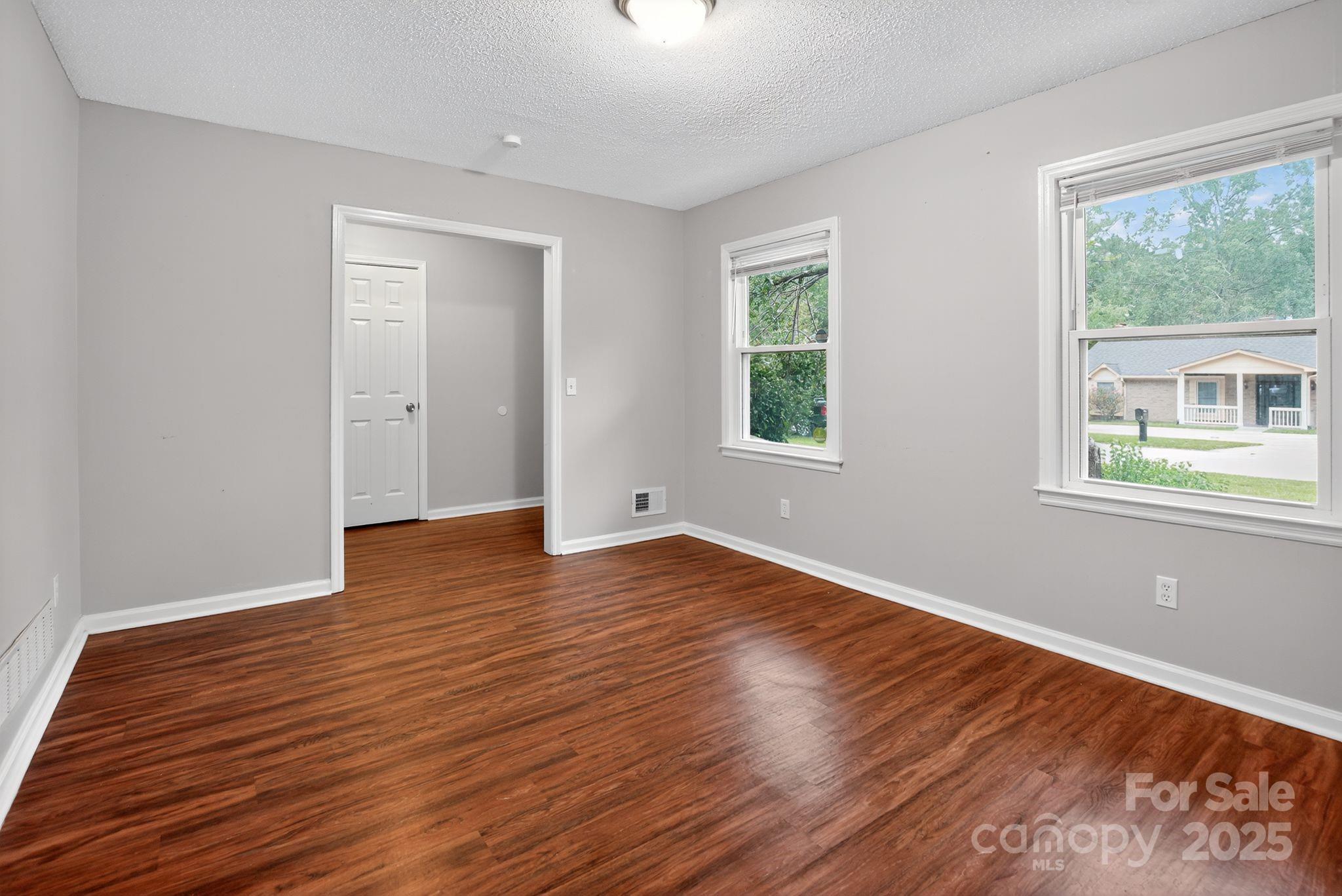 3725 Harrogate Road Columbia, SC 29210 - Photo 9 of 31 a view of an empty room with wooden floor and a window
