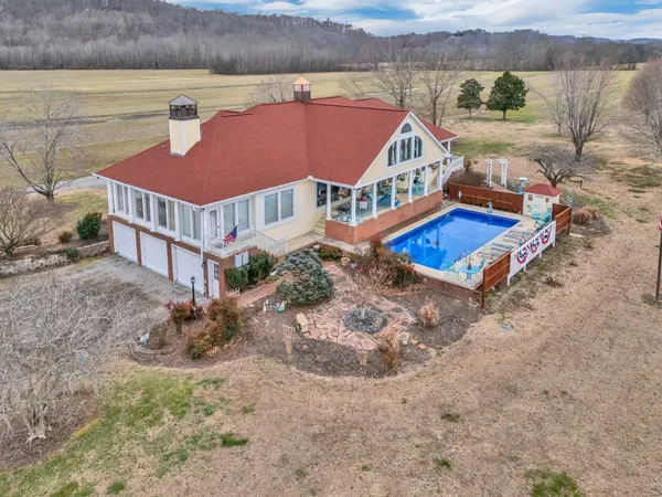 an aerial view of a house with a yard and a terrace