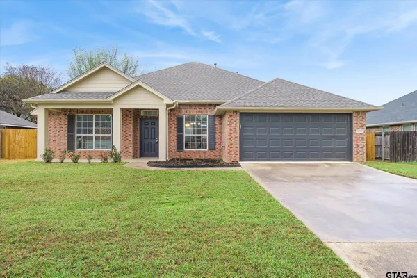 a front view of a house with yard