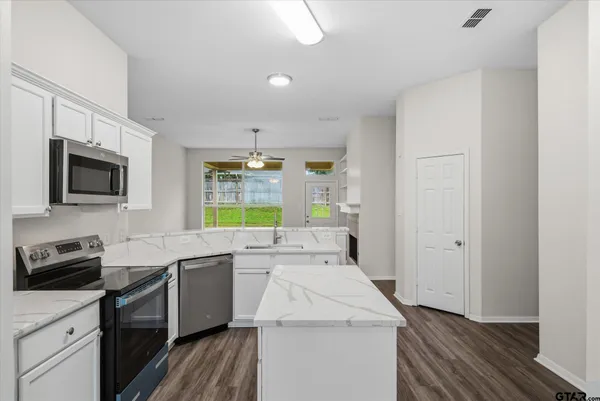 a kitchen that has a sink and a stove in it