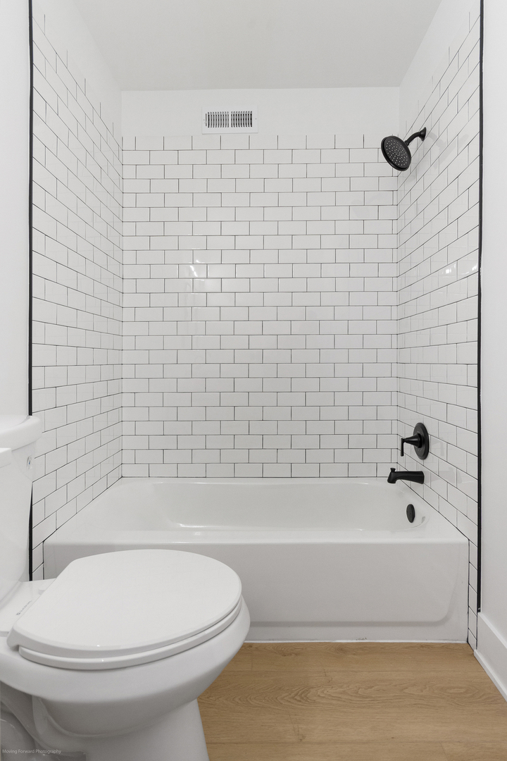 372 Windsong Court Bolingbrook, IL 60440 - Photo 26 of 29 a bathroom with a white toilet and a bathtub