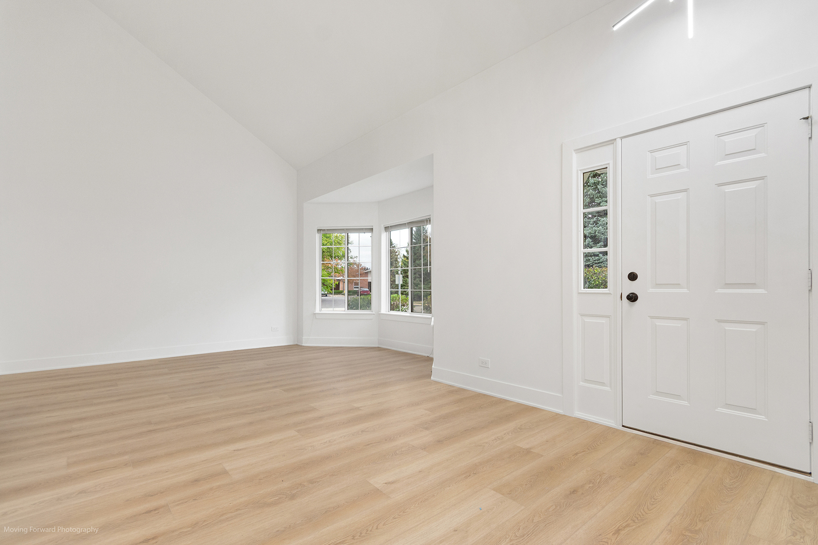 372 Windsong Court Bolingbrook, IL 60440 - Photo 6 of 29 a view of an empty room with wooden floor and a window