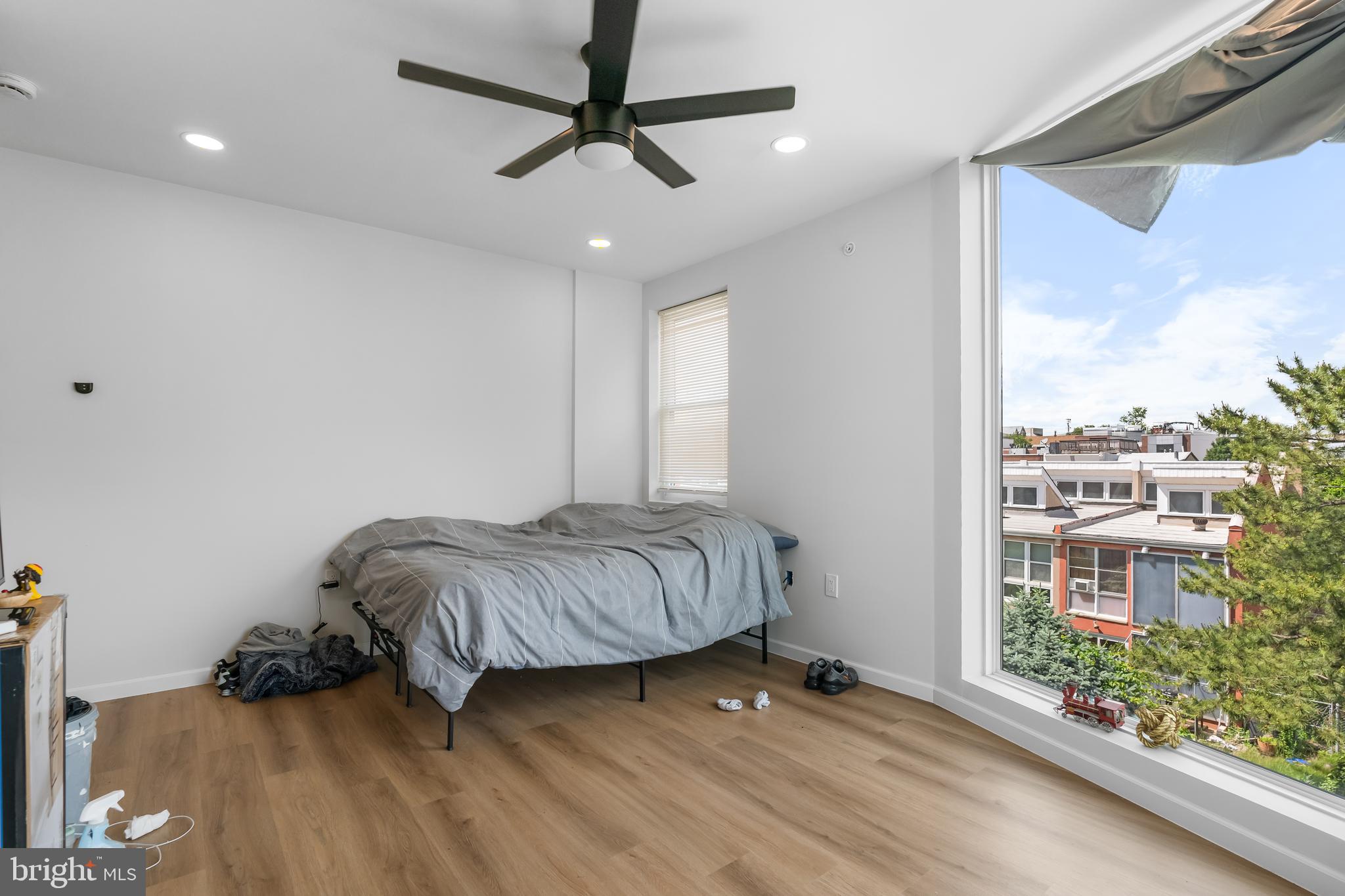 1242 North 15th Street, Unit 2 Philadelphia, PA 19121 - Photo 16 of 19 a living room with a bed furniture and a large window
