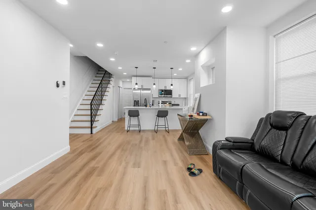 a living room with furniture and wooden floor