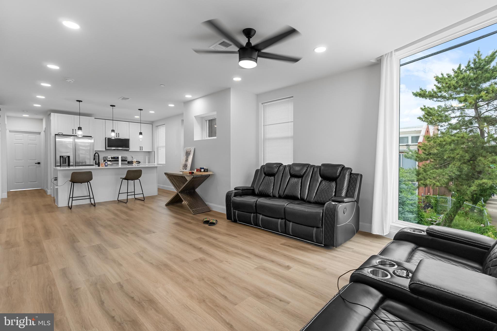 1242 North 15th Street, Unit 2 Philadelphia, PA 19121 - Photo 4 of 19 a living room with furniture and kitchen view