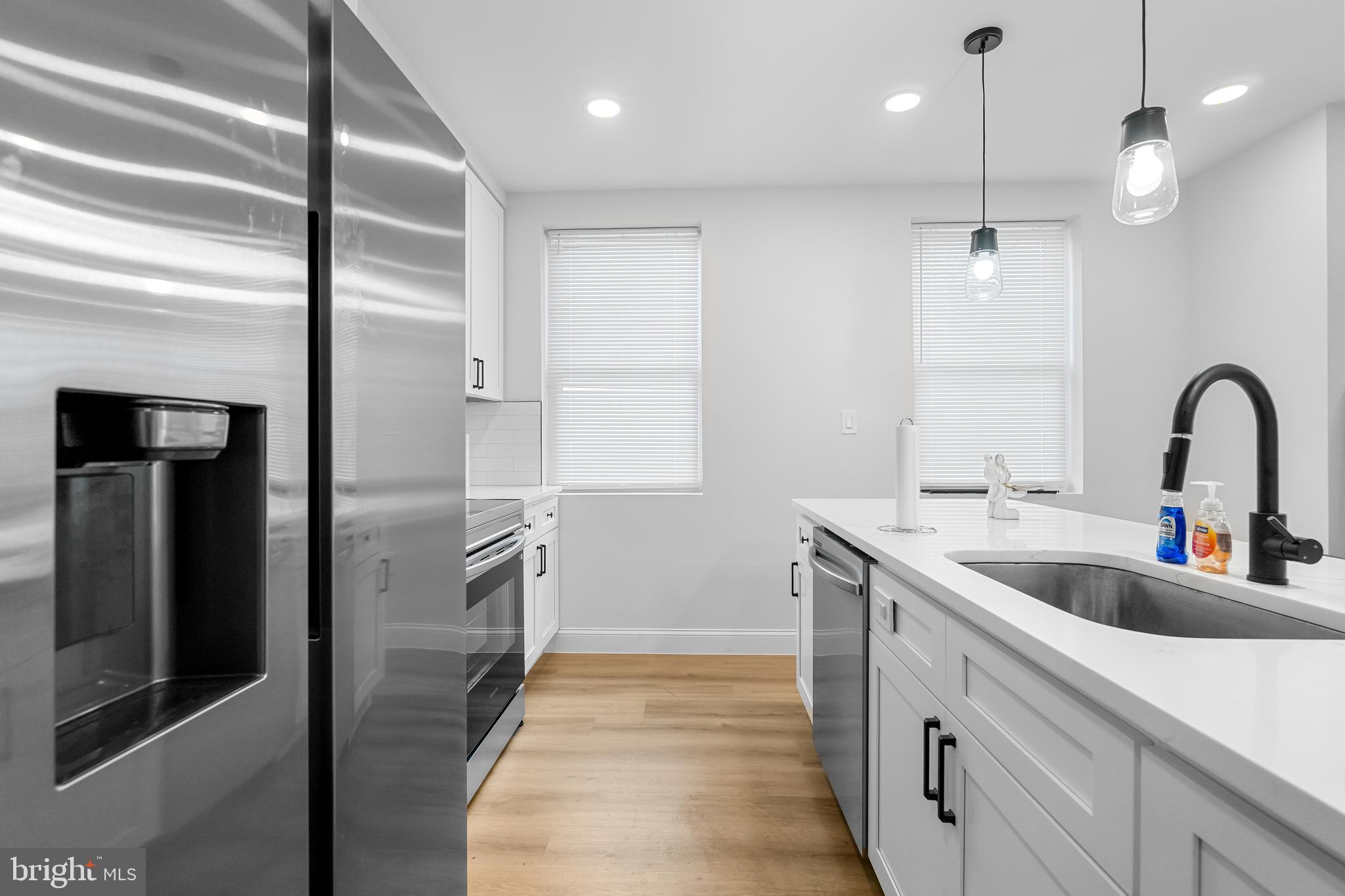1242 North 15th Street, Unit 2 Philadelphia, PA 19121 - Photo 7 of 19 a kitchen with a refrigerator sink and cabinets
