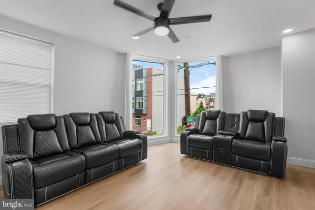 a living room with furniture and a large window