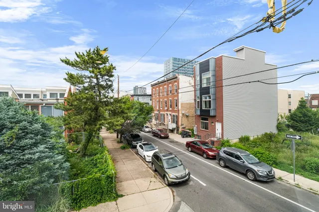 a view of a street with potted plants