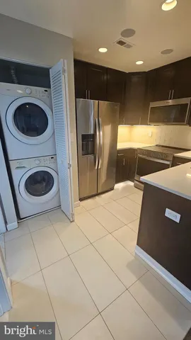a view of a refrigerator and washer in a kitchen