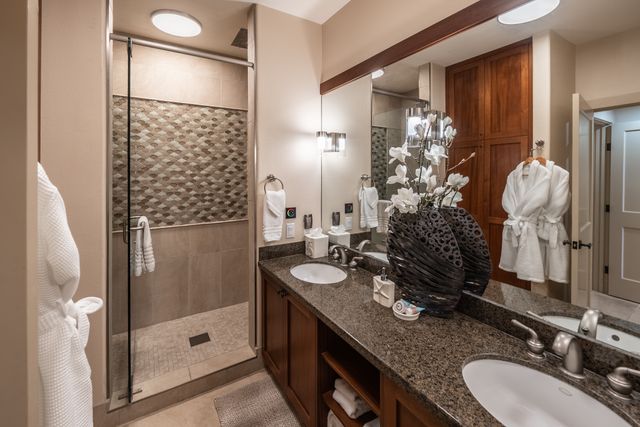 a bedroom with two beds and a chandelier