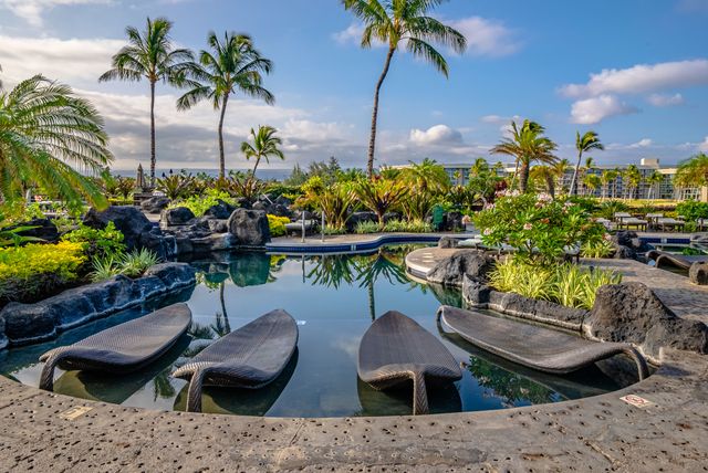 an outdoor sitting area with couch and umbrella