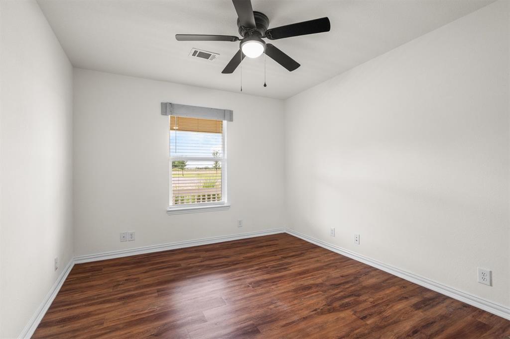 13132 Highway 78 Blue Ridge, TX 75424 - Photo 17 of 35 Bright room featuring wood-finish flooring, a contemporary ceiling fan with integrated lighting, and a window with blinds