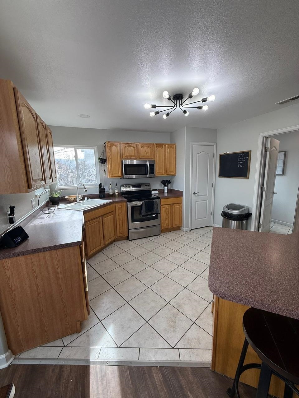746 Granite Drive Fruita, CO 81521 - Photo 5 of 19 a kitchen with granite countertop a stove top oven a sink dishwasher a dining table and chairs with wooden floor