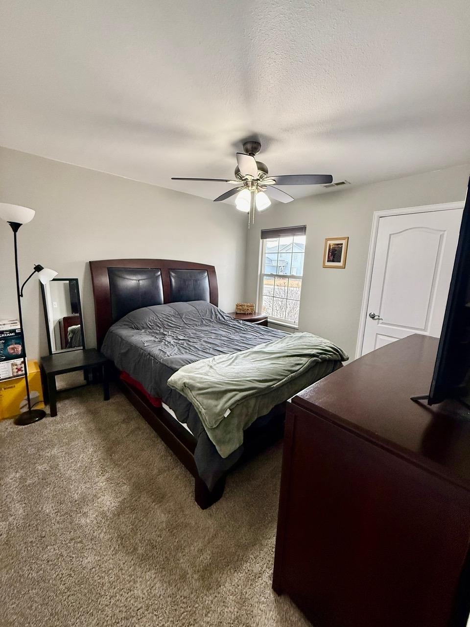 746 Granite Drive Fruita, CO 81521 - Photo 8 of 19 a bedroom with a bed and a chandelier