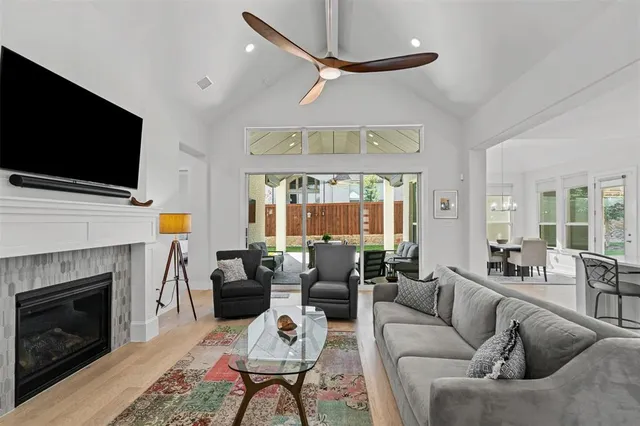 a living room with furniture a fireplace and a flat screen tv