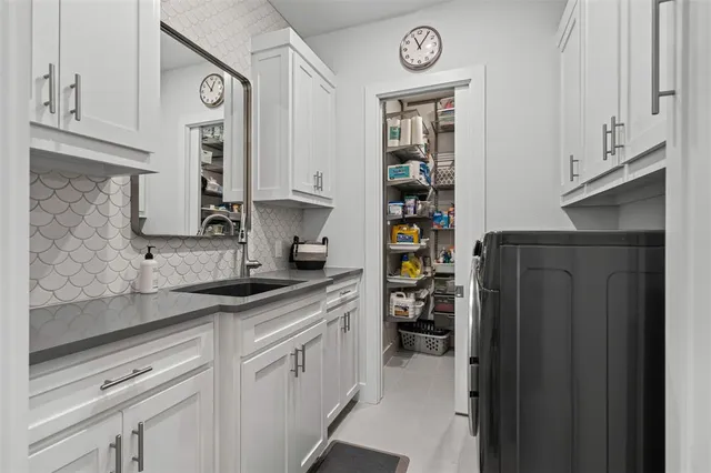 a kitchen with stainless steel appliances a sink and a refrigerator