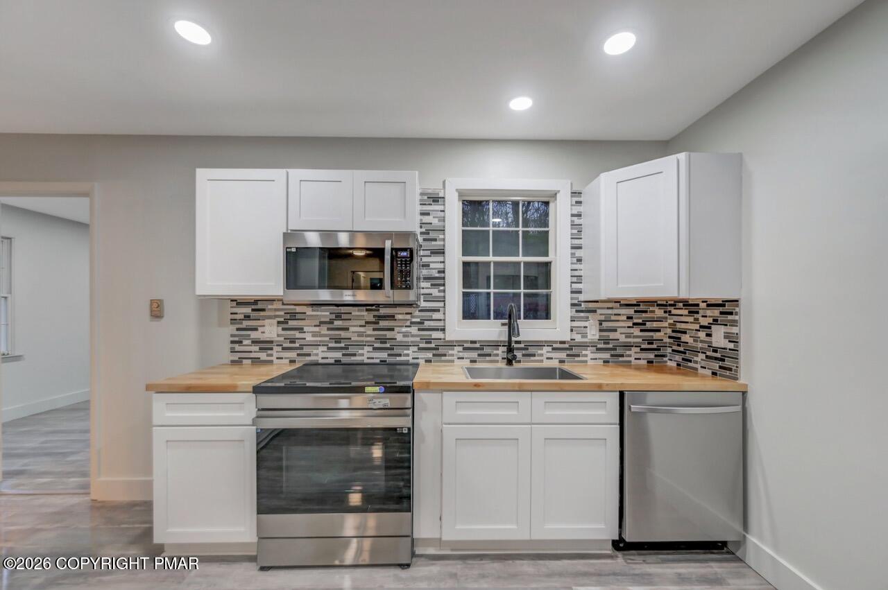 384 Devils Hole Road Cresco, PA 18326 - Photo 13 of 97 a kitchen with stainless steel appliances granite countertop a stove and a microwave