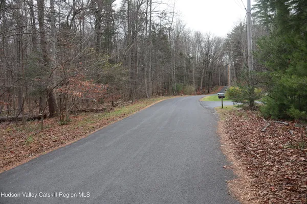 a wooden bench with view of trees