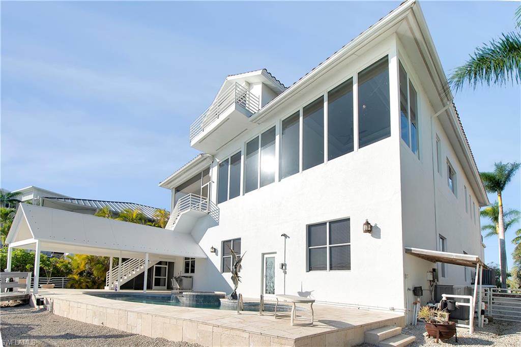 28 West Pelican Street Naples, FL 34113 - Photo 42 of 50 a view of a building with a street