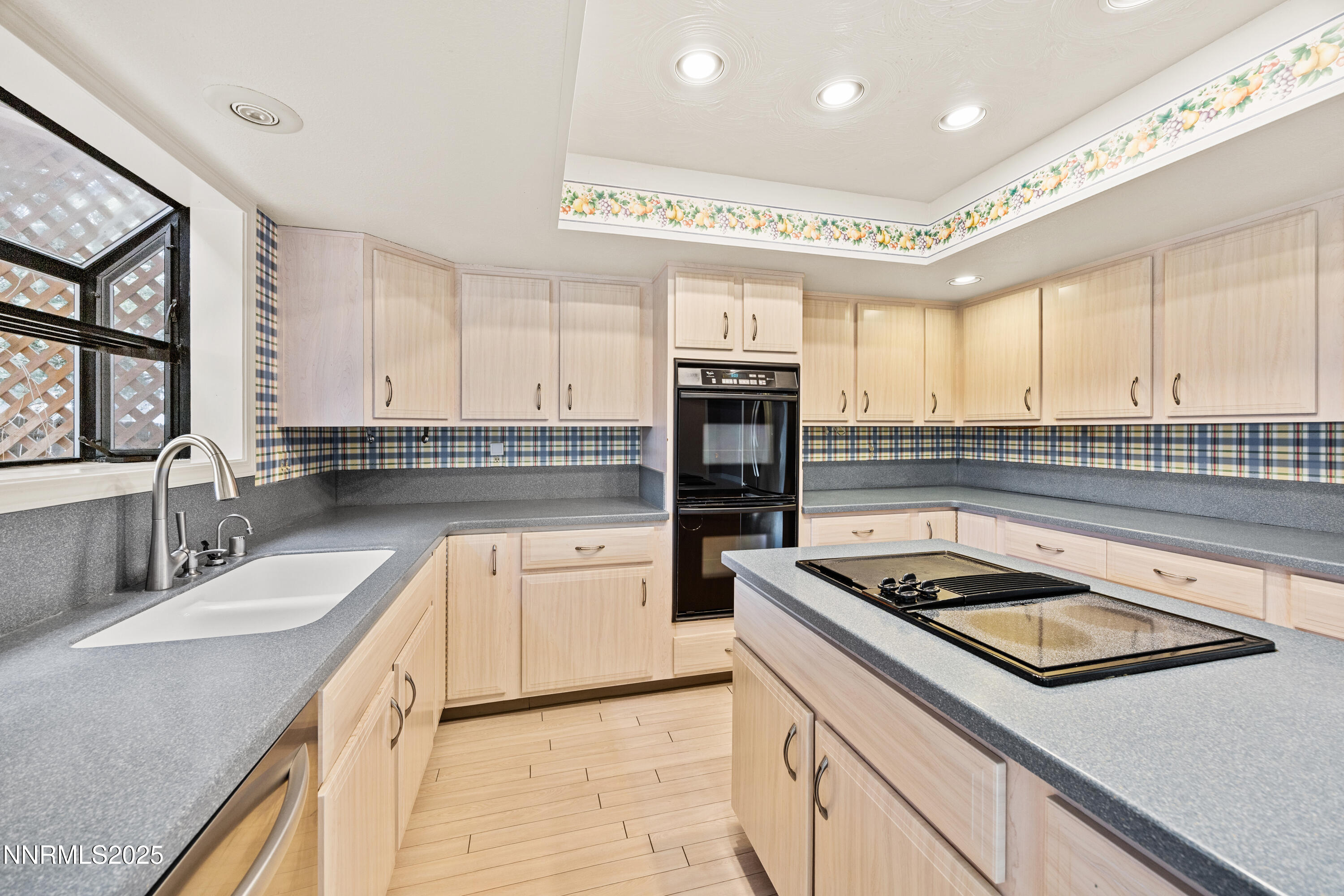 6299 Stone Valley Drive Reno, NV 89523 - Photo 11 of 70 a kitchen with kitchen island stainless steel appliances a sink stove and cabinets