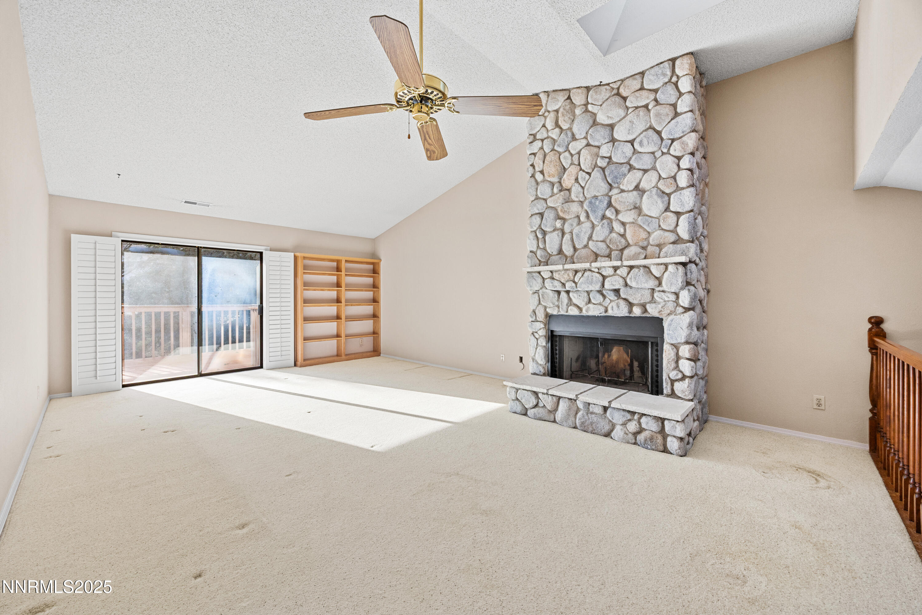 6299 Stone Valley Drive Reno, NV 89523 - Photo 19 of 70 a view of an empty room with a fireplace and a window