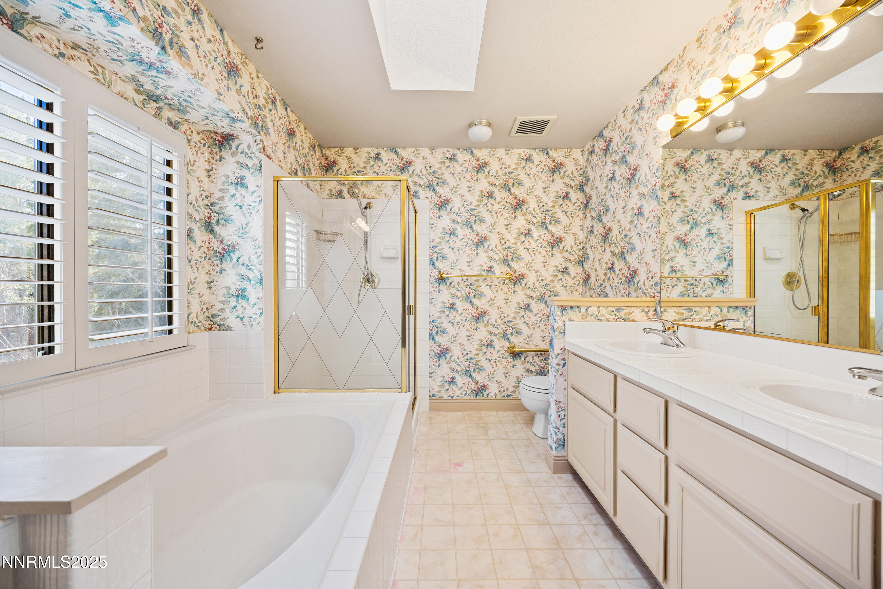6299 Stone Valley Drive Reno, NV 89523 - Photo 25 of 70 a spacious bathroom with a sink a mirror a shower and a bathtub