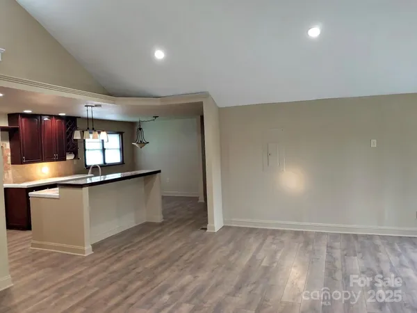 a kitchen with stainless steel appliances granite countertop a sink stove and cabinets
