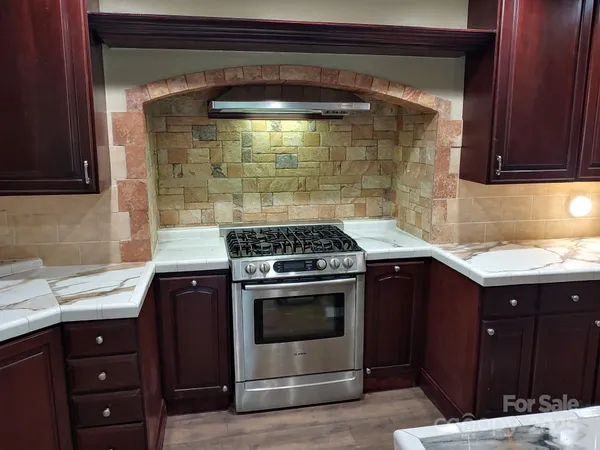 a kitchen with a sink a stove and refrigerator