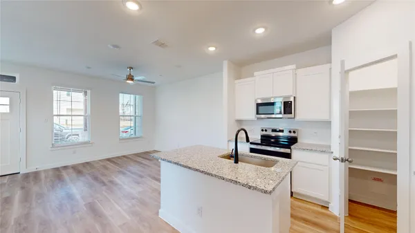 a kitchen with a sink stove and cabinets