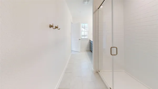 a white toilet sitting next to a white wall