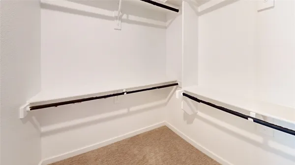 a view of a room with wooden floor and entryway