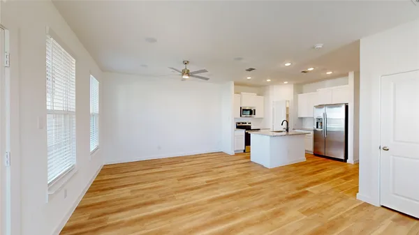 a room with a bed and kitchen view