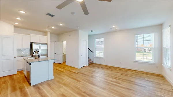 a view of a kitchen with microwave and cabinets