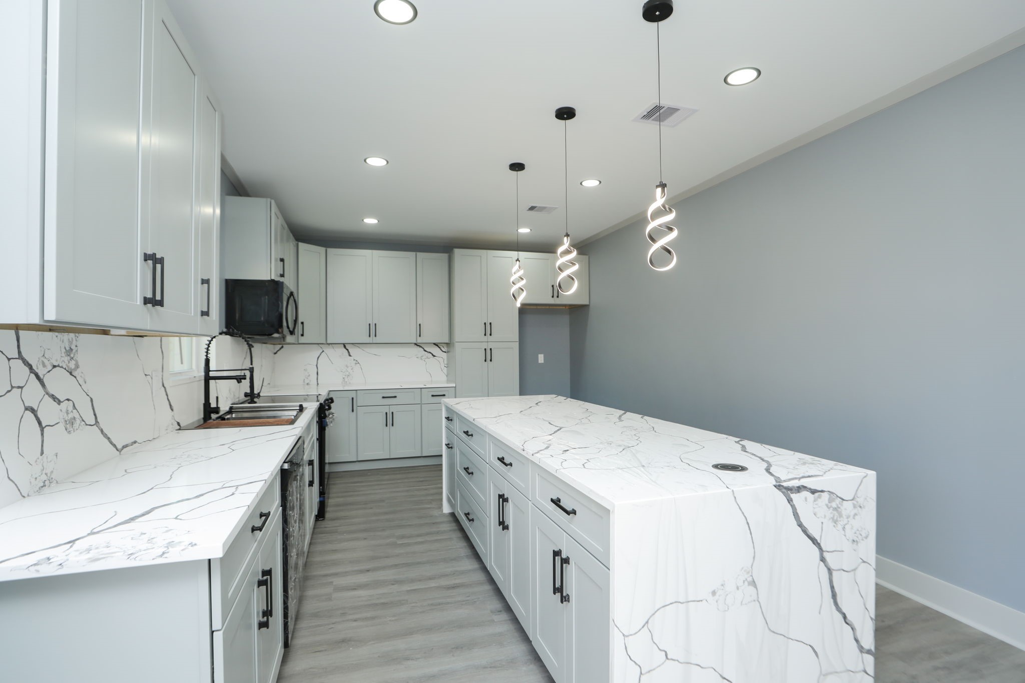 4047 Juliet Street Houston, TX 77087 - Photo 12 of 38 a kitchen that has a lot of white cabinets and stainless steel appliances