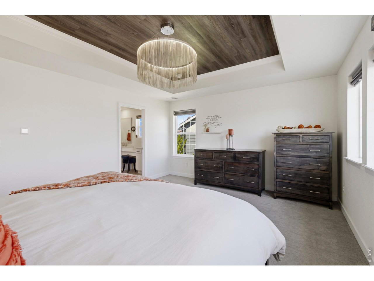 2910 Water View Street Timnath, CO 80547 - Photo 23 of 50 a bed room with a bed and a chandelier