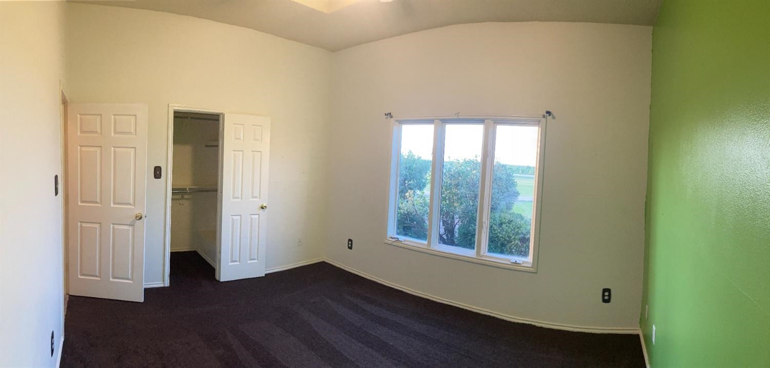 1819 County Road 130 Plainview, TX 79072 - Photo 17 of 24 an empty room with wooden floor and windows
