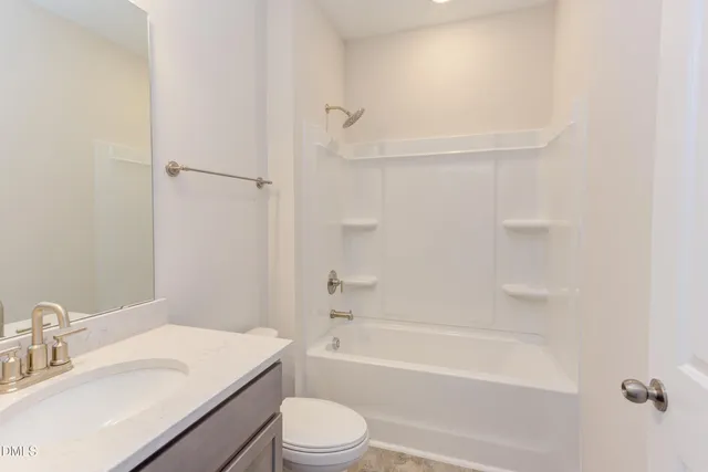 a bathroom with a sink toilet vanity and shower