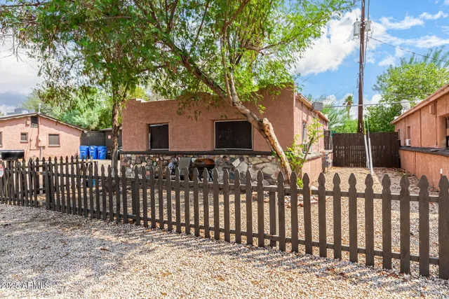 a front view of house with wooden fence