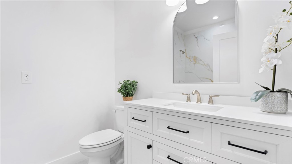358 South Halcyon Road Arroyo Grande, CA 93420 - Photo 25 of 32 a bathroom with a toilet sink and mirror