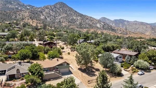 an aerial view of a house with a yard