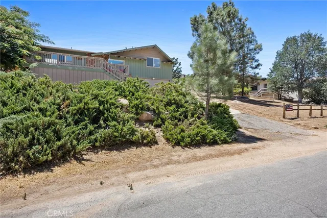 a kitchen with stainless steel appliances granite countertop wooden cabinets a dining table and chairs